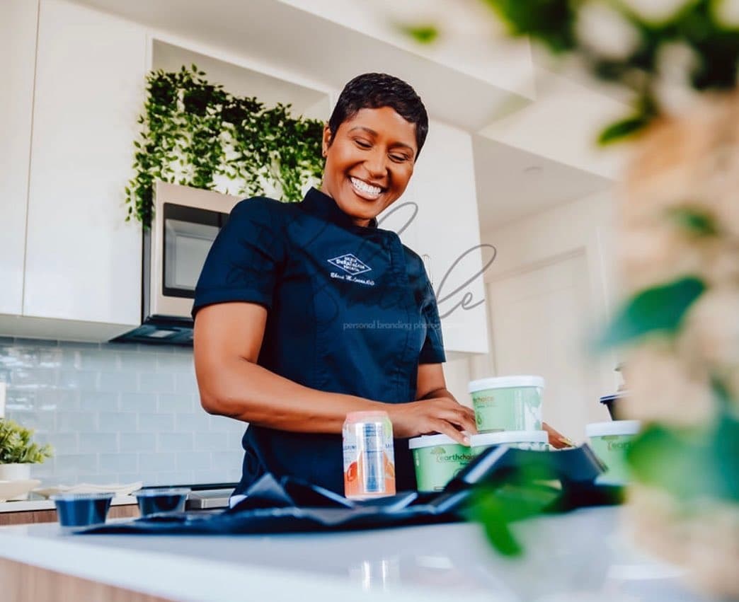 Chef Eboni Darnell Lucas plating a dish in a private kitchen
