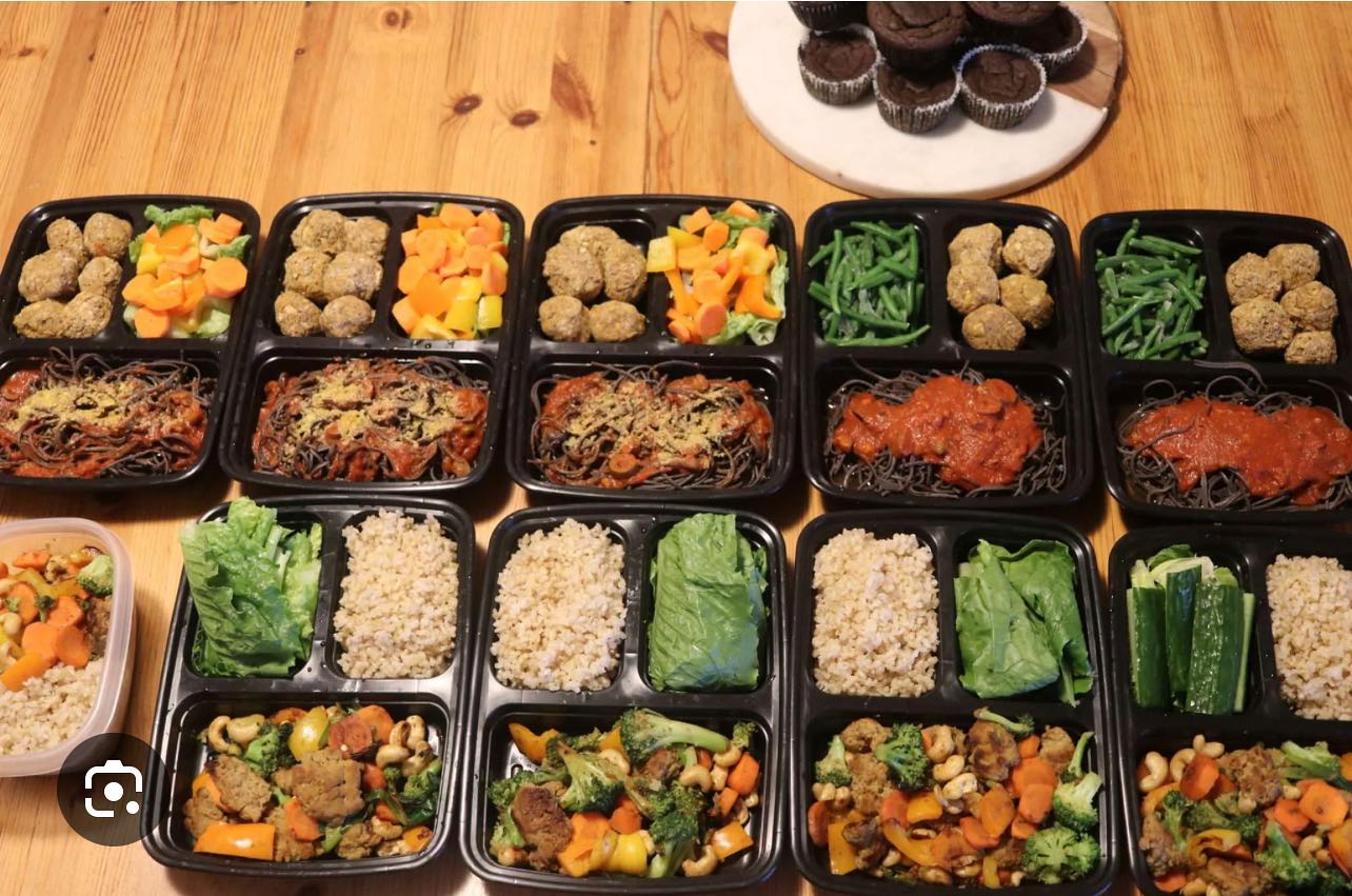 Variety of meal prep containers with meatballs, pasta, quinoa and stir-fry