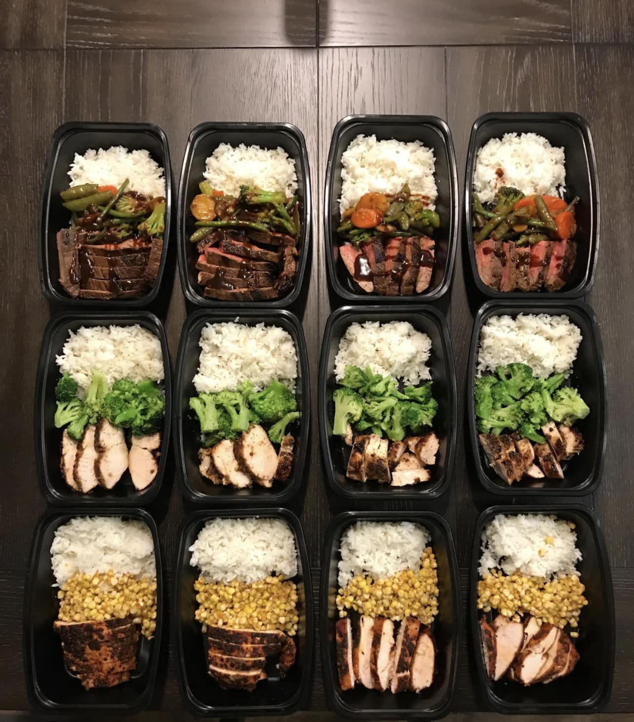 Protein meal prep with steak, chicken, rice, broccoli and vegetables